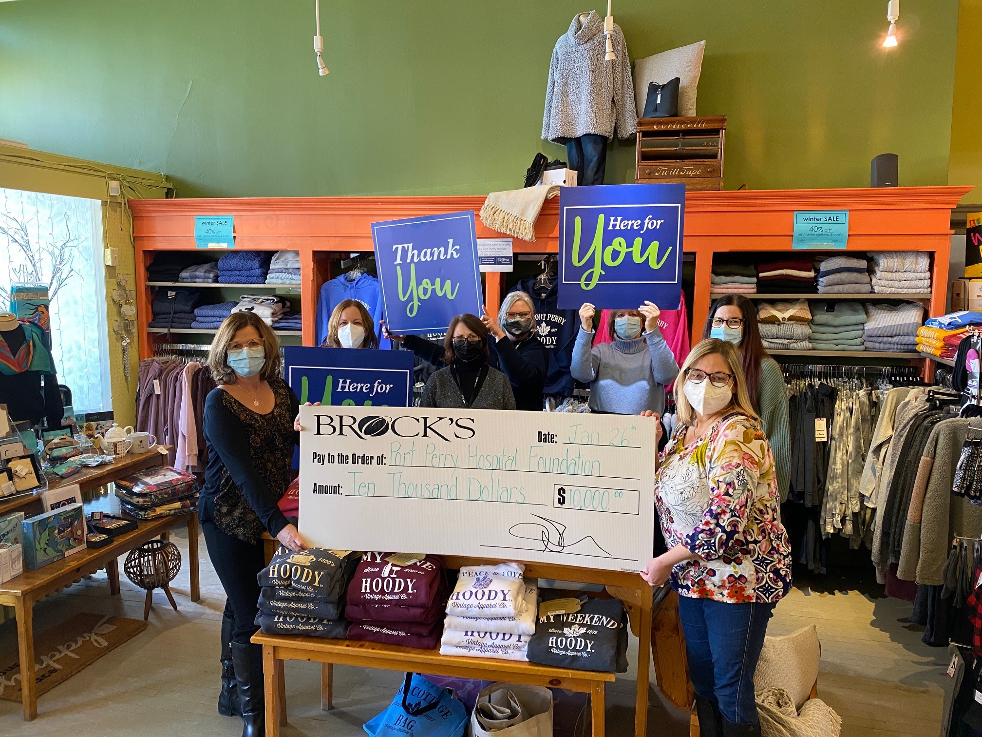 Cheque presentation from Brock's staff around and holding the cheque for 10,000